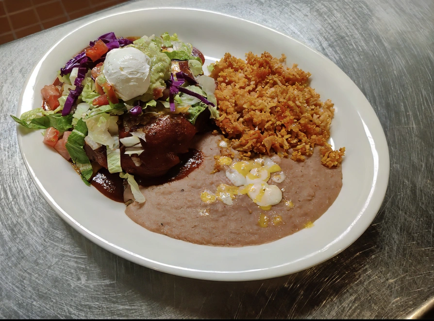 Chaupa A sopapilla fried golden brown and stuffed with a variety of delicious combinations. Smothered in chile verde or enchilada sauce, and topped with cheddar and Monterey jack cheese, lettuce, tomato, sour cream, and guacamole. Served with spanish rice or fideo and refried beans.