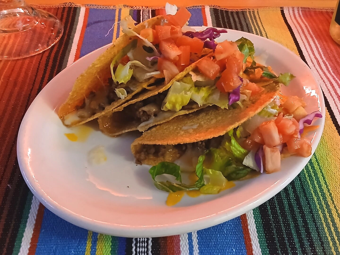 Ala Carte Hardshell Tacos (3) Topped with cheddar and Monterey Jack cheese, lettuce, tomato, and sour cream.