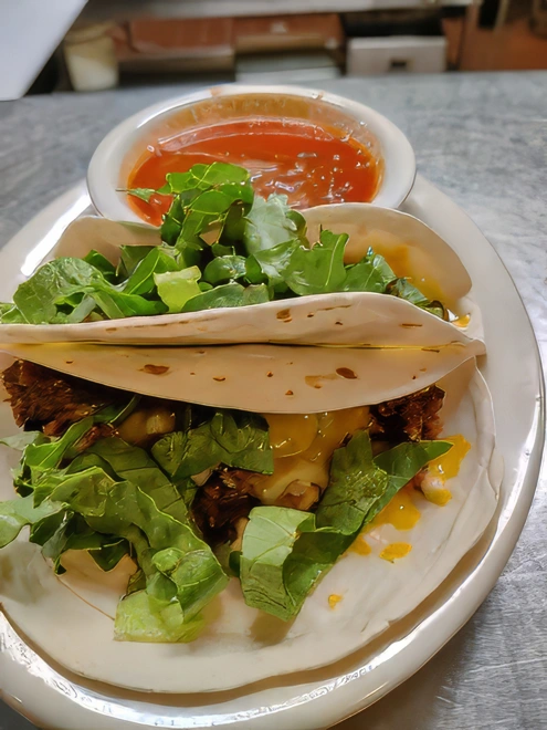 Kids Taco Meal Two soft flour ground sirloin tacos garnished with a cheese blend, lettuce and tomato. Served with a side of spanish rice, fideo, or refried beans.