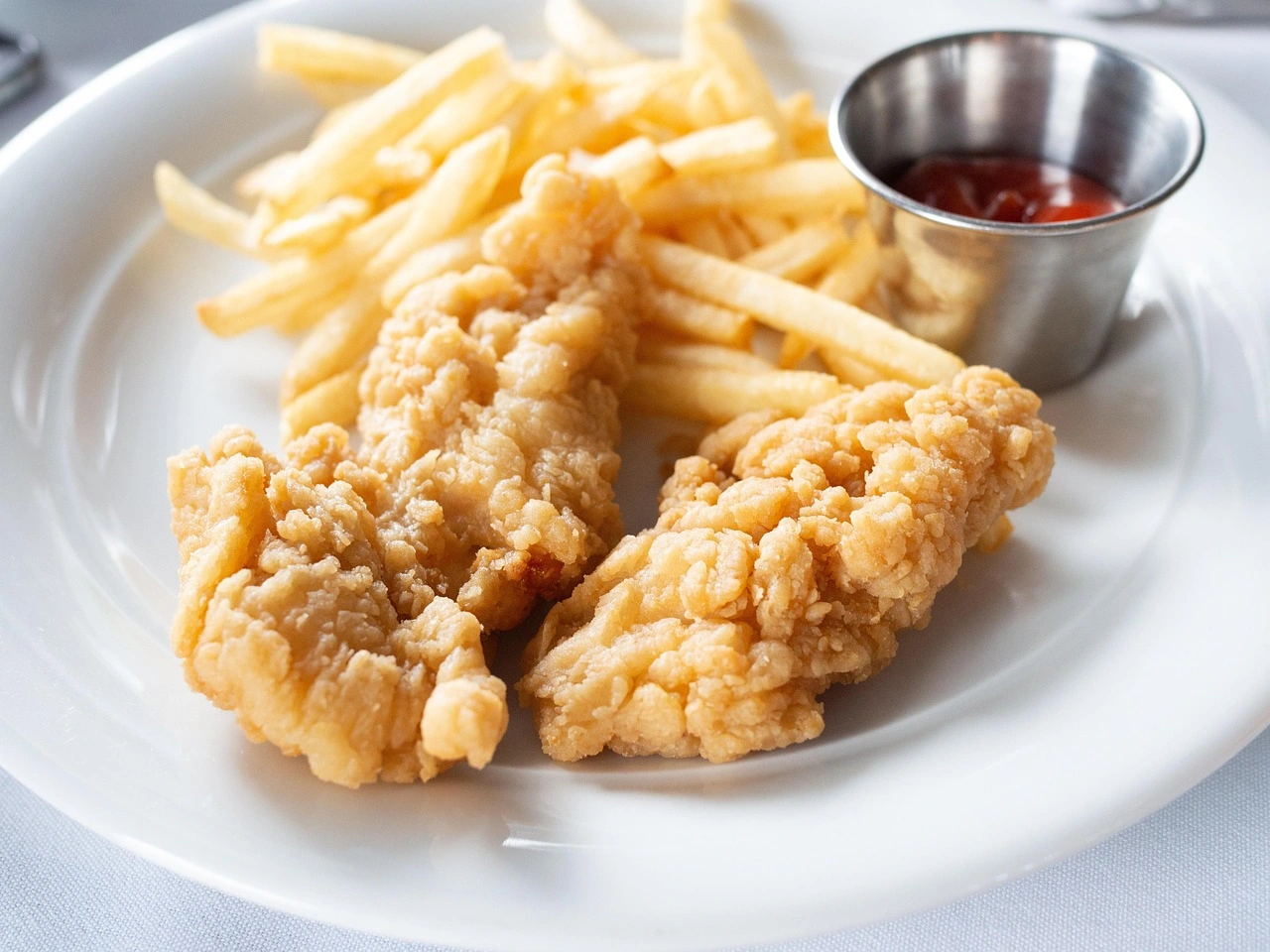 Kids Chicken Strip Meal Two chicken strips served with handcut fries.